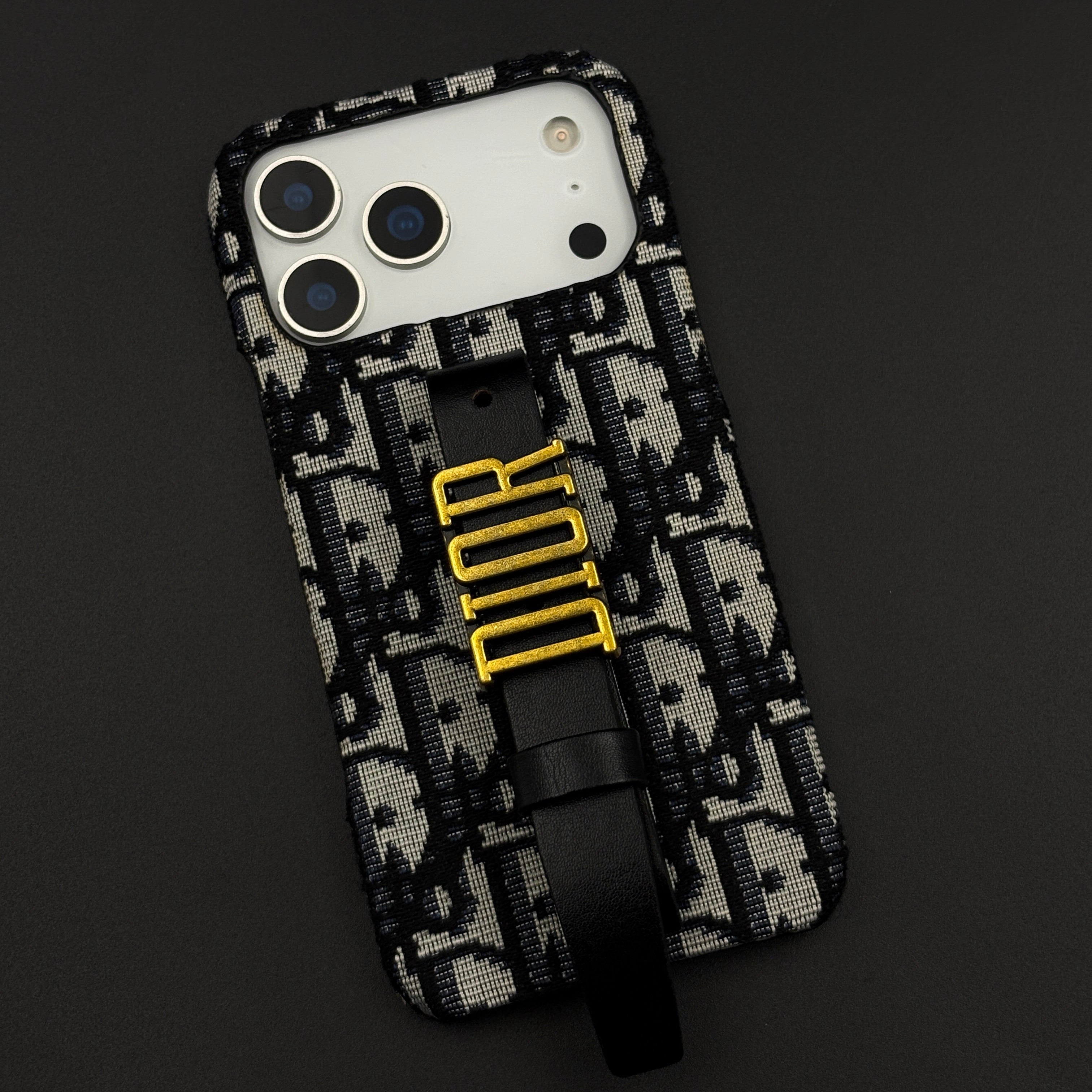 Luxury Fashion Brand Embroidered CD Belt Strap Case for iPhone 17 Series with Gold Metal Emblem